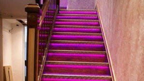 A staircase with purple LED lighting. - LG Thai Derm Spa & Guesthouse (Loughborough)