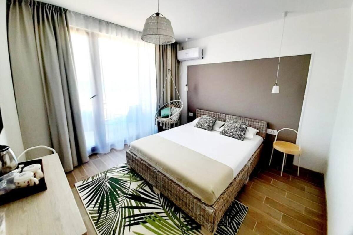 Una habitación de hotel moderna con una cama grande, una mesa de comedor y una silla.