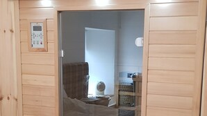 A sauna with a control panel, a bench, and a ventilation system. - The Grey Gull Hotel (Lochgilphead)