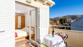 Apartment, Balcony, City View (A3) | Living area | 82-cm flat-screen TV with satellite channels, TV