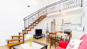 A living room with a staircase, a dining area, and a kitchen. - Nikola Apartments (Dubrovnik)