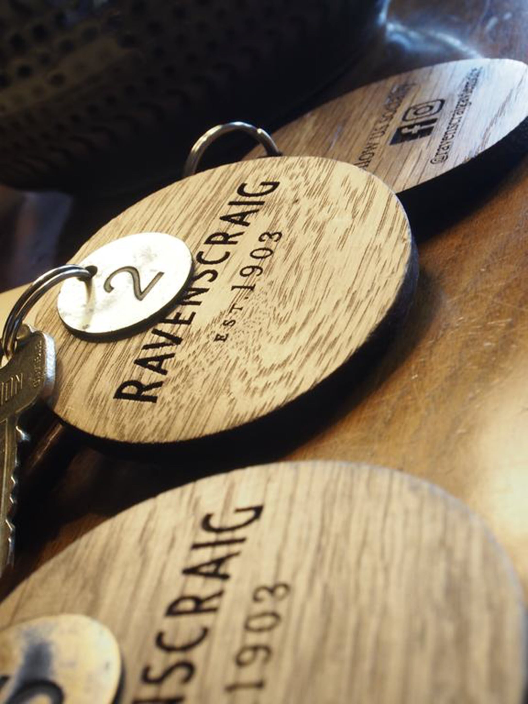 Wooden plaques with engraved text and numbers, likely used for identification or tracking.