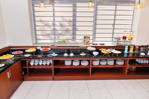 A buffet setup with various food items and a coffee station. - A25 Premium Hotel - 705 Lac Long Quan (Hanoi)