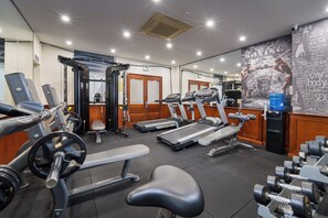 A gym with treadmills, weight machines, and dumbbells. - A25 Premium Hotel - 705 Lac Long Quan (Hanoi)