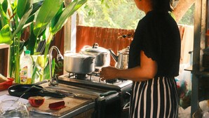 A kitchen with a wooden counter, a stove, and various cooking utensils. - Siem Reap Homesteading (Siem Reap)