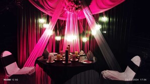 A table set for a meal with candles, plates, and a centerpiece. - The Orchard Retreat & Spa, Srinagar (Srinagar)