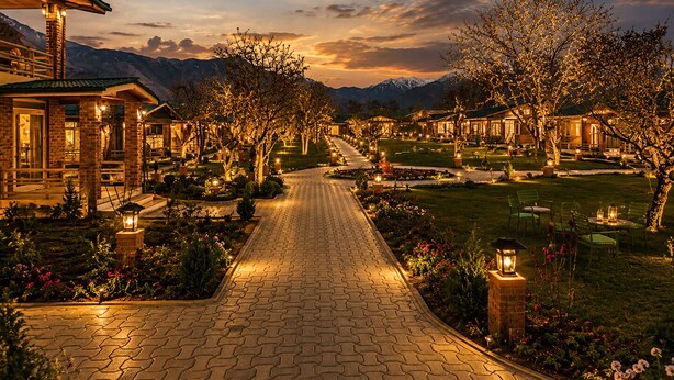 A pathway leading to a row of houses with a mountain backdrop. - The Orchard Retreat & Spa, Srinagar (Srinagar)