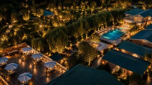 An aerial view of a resort with a swimming pool, outdoor seating, and well-lit pathways. - The Orchard Retreat & Spa, Srinagar (Srinagar)
