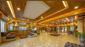 A spacious lobby with wooden beams, a marble floor, and a sofa area. - The Orchard Retreat & Spa, Srinagar (Srinagar)