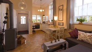 A modern kitchen with white cabinets, a dining table, and a built-in oven. - Villa Ruth (Reichshof)