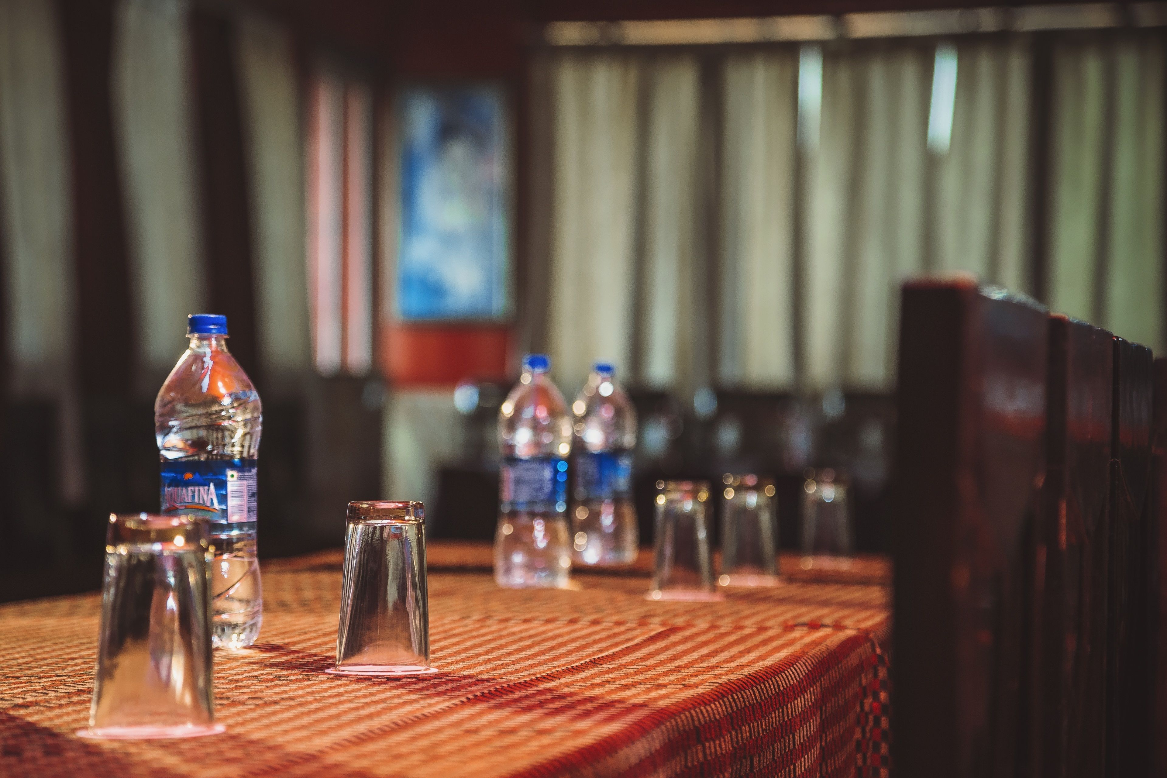 A table with water bottles and glasses, suggesting a dining or meeting area.