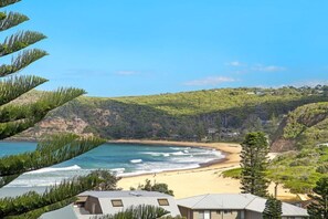 A coastal view with a beach, ocean, and hills. - Beach House for Family or Couples with views & 2 minute walk to beach and shops (Copacabana)