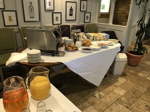 A breakfast buffet with various food items, a coffee machine, and a juice pitcher. - Deddington Arms (Banbury)
