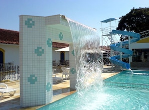 A pool area with a water slide and a tiled structure. - JS Park Hotel (Sao Lourenco)