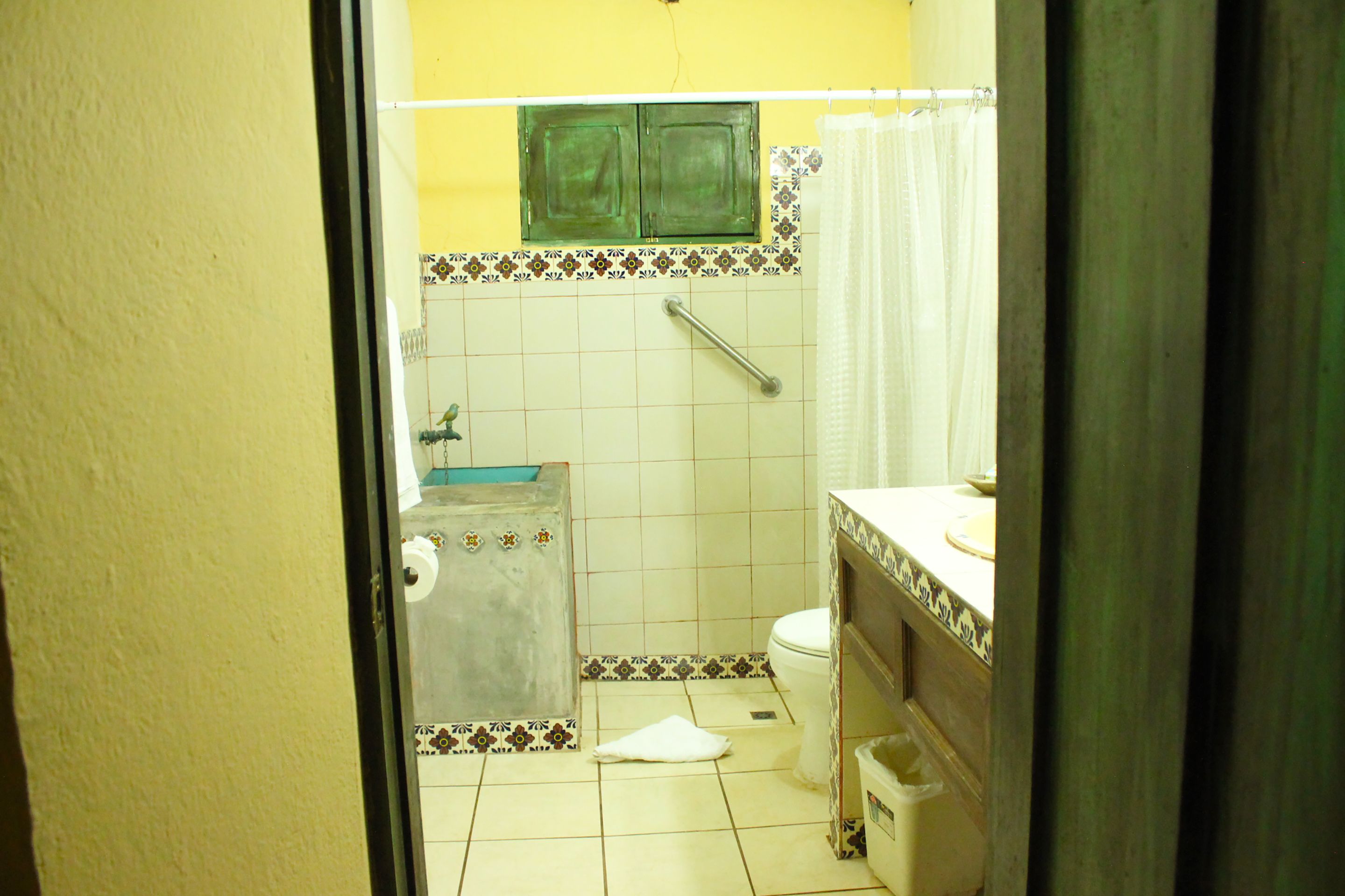 A bathroom with a toilet, sink, and shower.