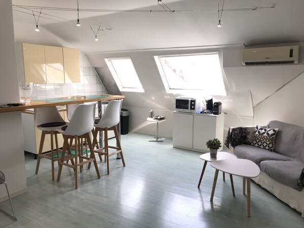 A modern apartment with a kitchen, dining area, and living space. It features a loft design with skylights, a kitchenette, and a sofa. - Loft for 2–4 people, Place du Diamant, downtown, with garage. (Ajaccio)
