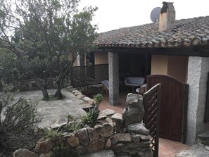 A rustic stone house with a tiled roof, a satellite dish, and a wooden gate. - DELICIOUS HOUSE COMPLETELY RENOVATED  (Punta Molara)