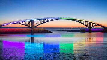 A bridge with a clear view of its structure and the calm water below.