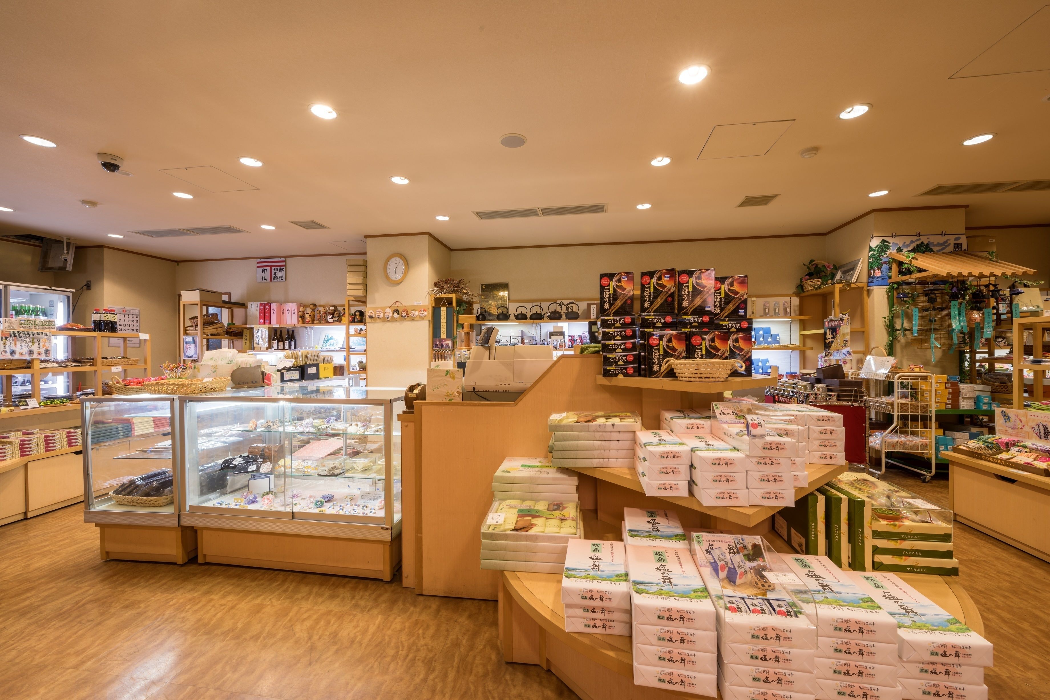 A store interior with display cases, shelves, and a counter.