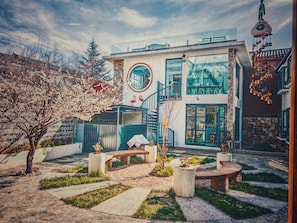 A modern building with a circular window, a staircase, and a balcony.