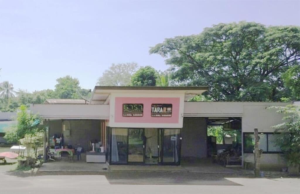 A building with a sign that reads 'TARA' and a partially visible sign with '5.5' on it.