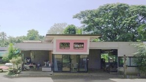 A building with a sign that reads 'TARA' and a partially visible sign with '5.5' on it. - Tara Resort Nakae Renu (Na Kae)