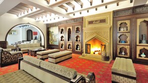 A luxurious living room with ornate furniture, a fireplace, and a large mirror. - Agacli Hotel (Aksaray)