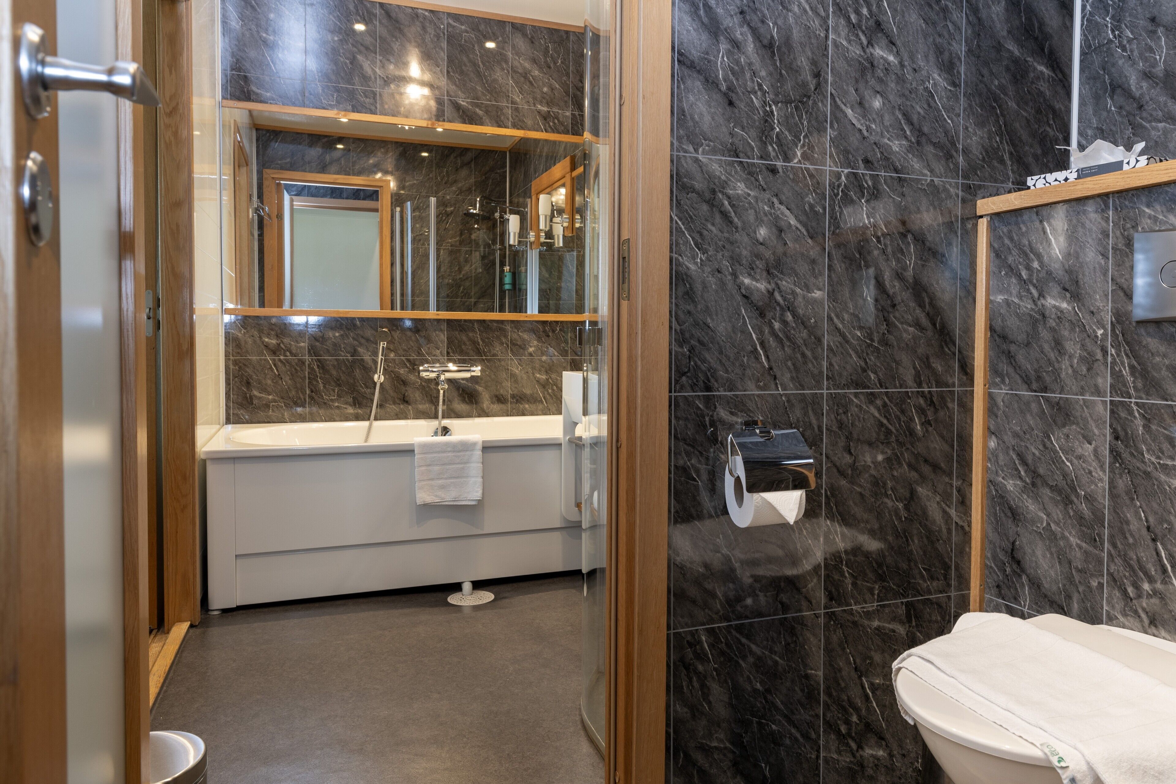 premium junior suite | bathroom | shower, designer toiletries, hair dryer, towels