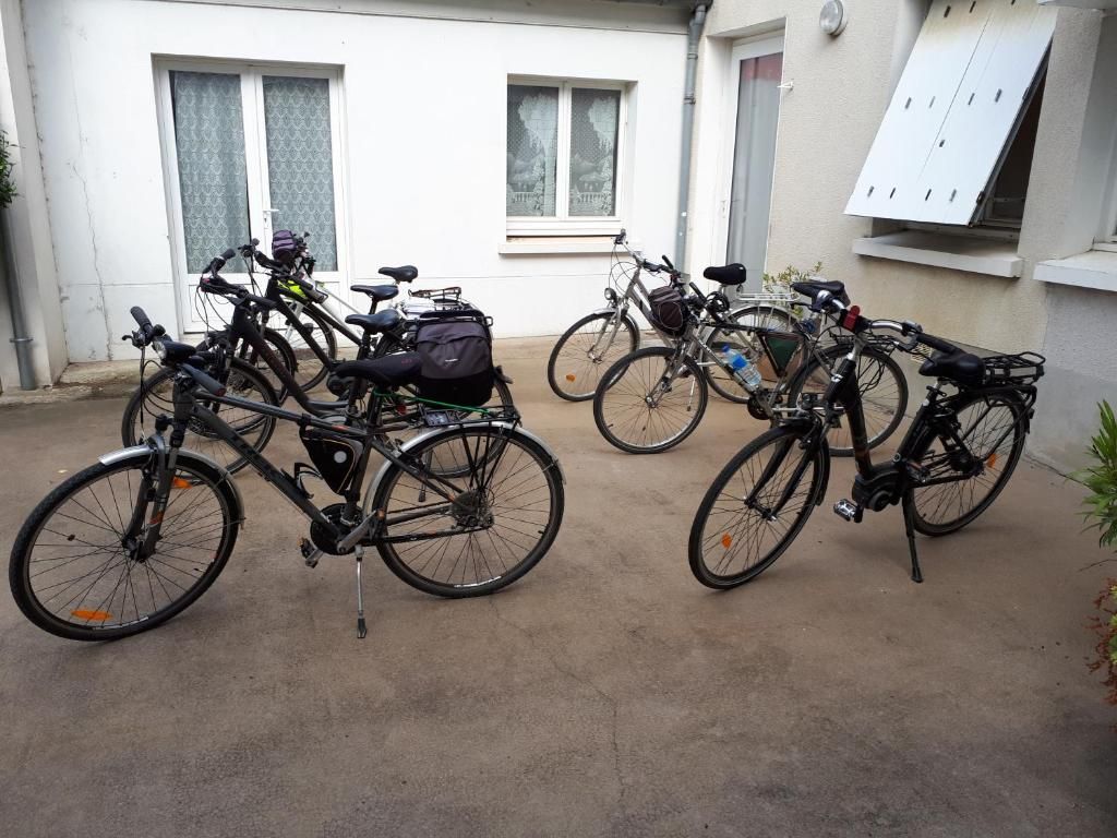 Bicycles parked outside a building with windows and a door.