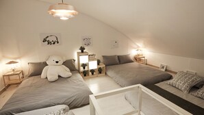 A cozy bedroom with two beds, a white teddy bear, and a small table. - Tribear House 2 (Seoul)