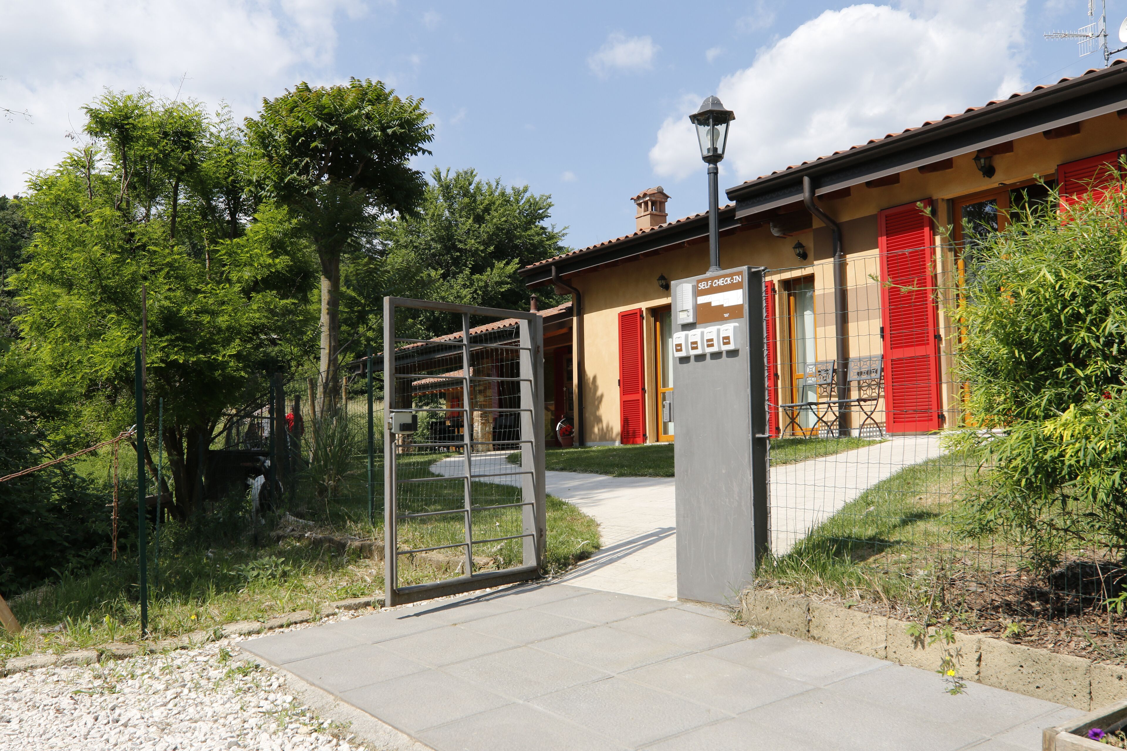 A building with a red door and a self-check-in kiosk.
