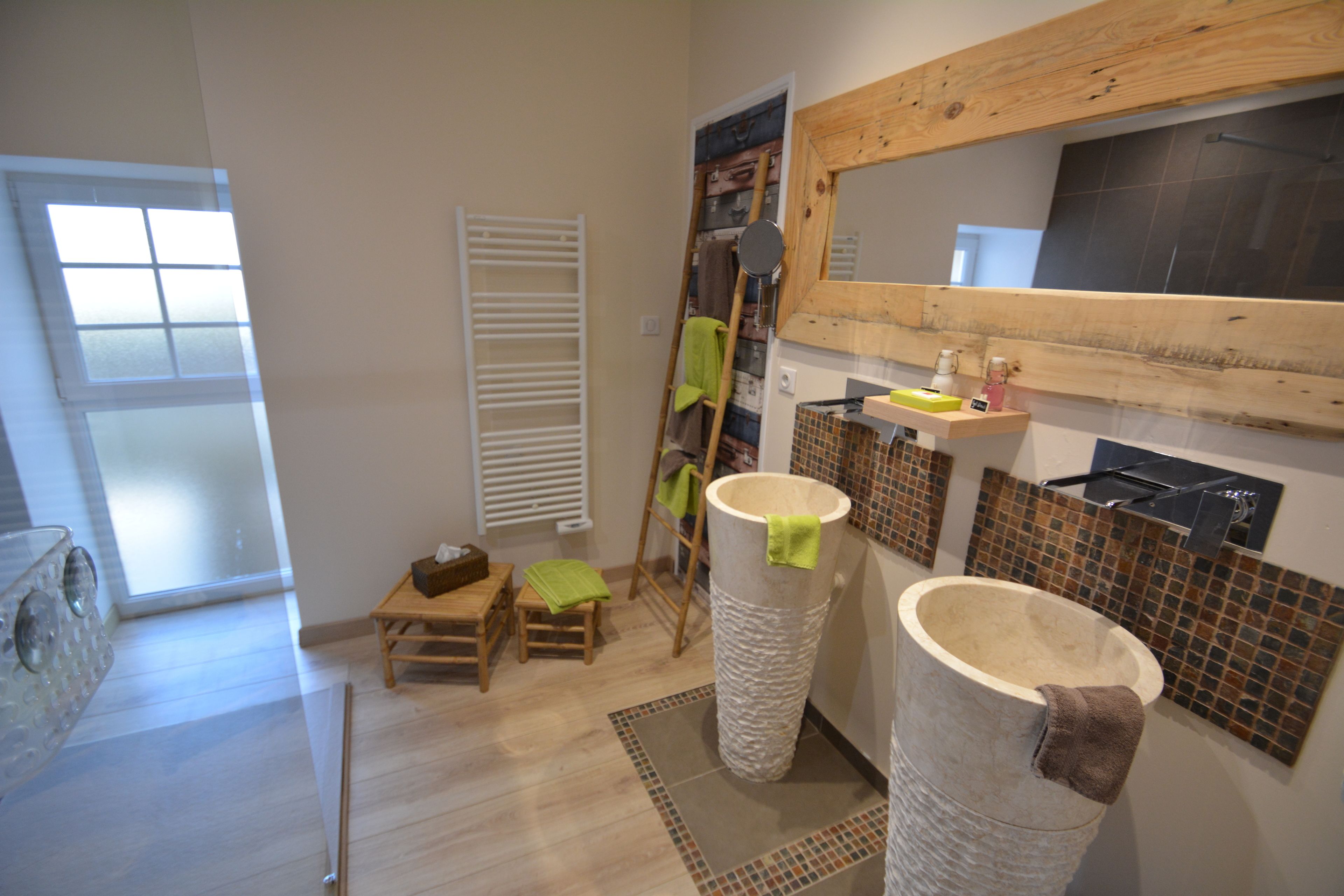 A bathroom with a large stone basin, a wooden ladder, a small wooden stool, and a tiled backsplash.