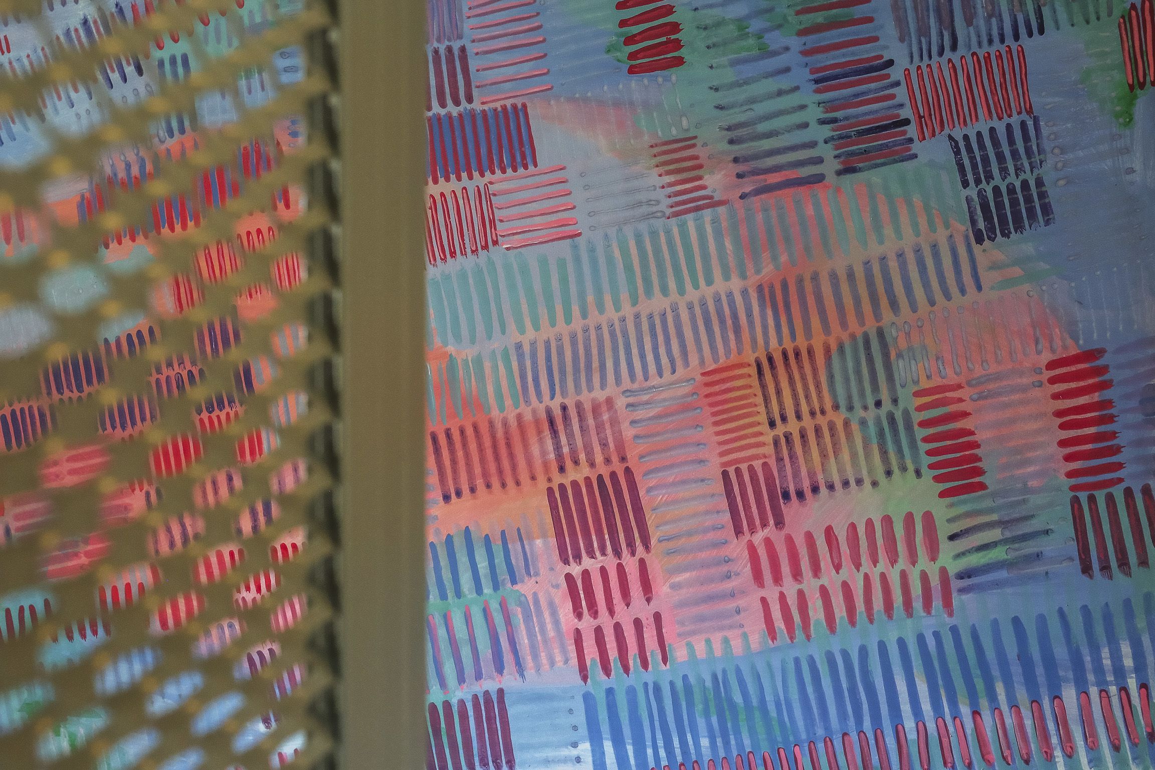A patterned wall with a grid-like design.