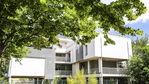A modern multi-story building with balconies and large windows. - B&B WarmUp Grosseto (Grosseto)