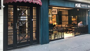 The exterior of the Old Port Hotel with a marquee sign and a coffee shop named Peak Coffee House visible through the entrance. - Old Port Hotel (Istanbul)