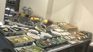 A buffet with various food items and utensils. - Old Port Hotel (Istanbul)