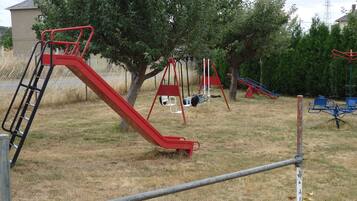 A playground with various play structures including slides and swings.