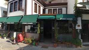 A building with a green awning and a sign reading "Ziya Bey Konagi".