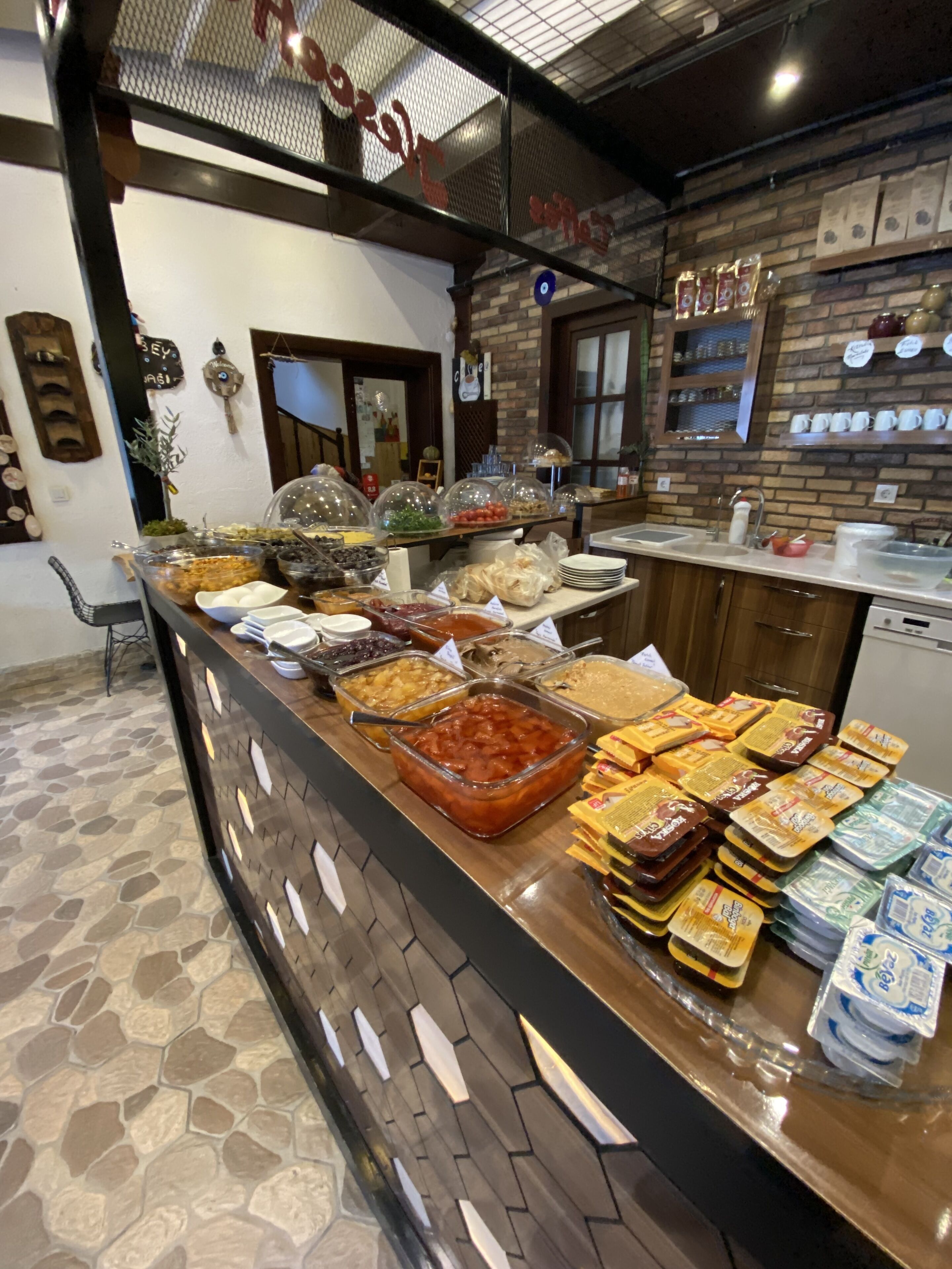 A buffet area with various food items and condiments.