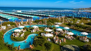 A resort with multiple swimming pools, sun loungers, and umbrellas.