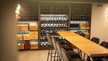 A wine cellar with wooden shelves and a long table.