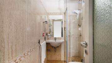 Ein Badezimmer mit Waschbecken, Spiegel und Dusche.