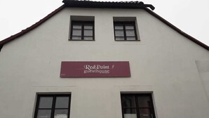 A building with a sign reading "Red Point guesthouse."