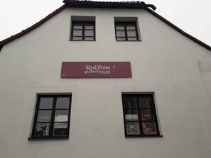 A building with a sign reading "Red Point guesthouse."