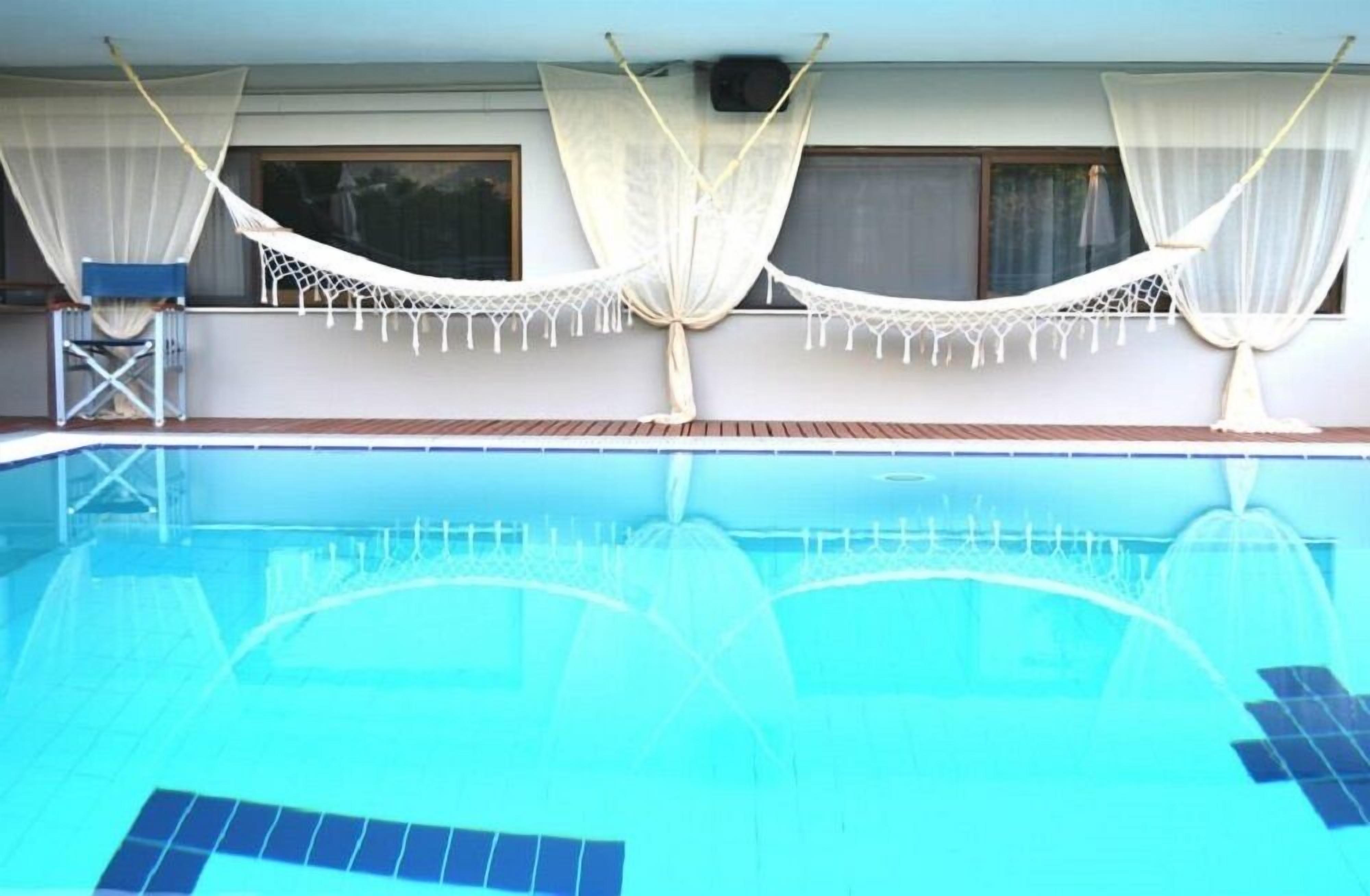 seasonal outdoor pool, pool umbrellas, pool loungers