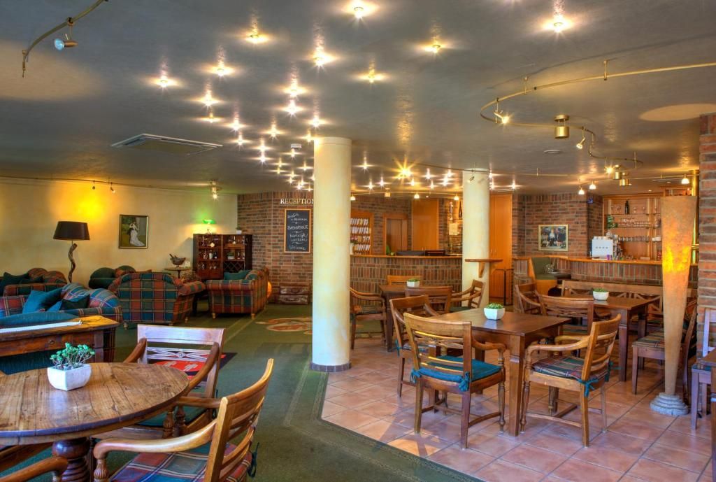 A cozy interior with a bar area, seating, and a reception desk.