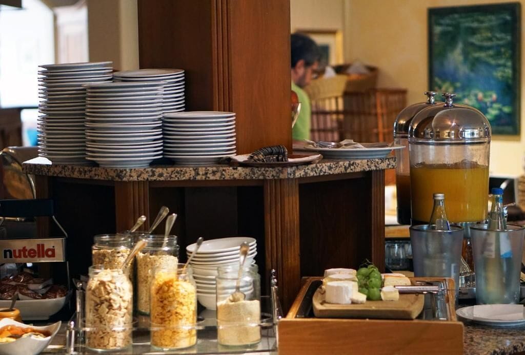 A buffet setup with various food items and utensils.