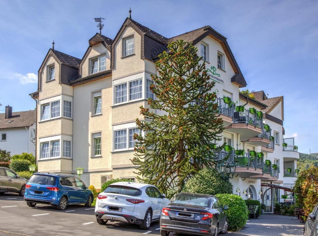A multi-story residential building with a parking area in front.