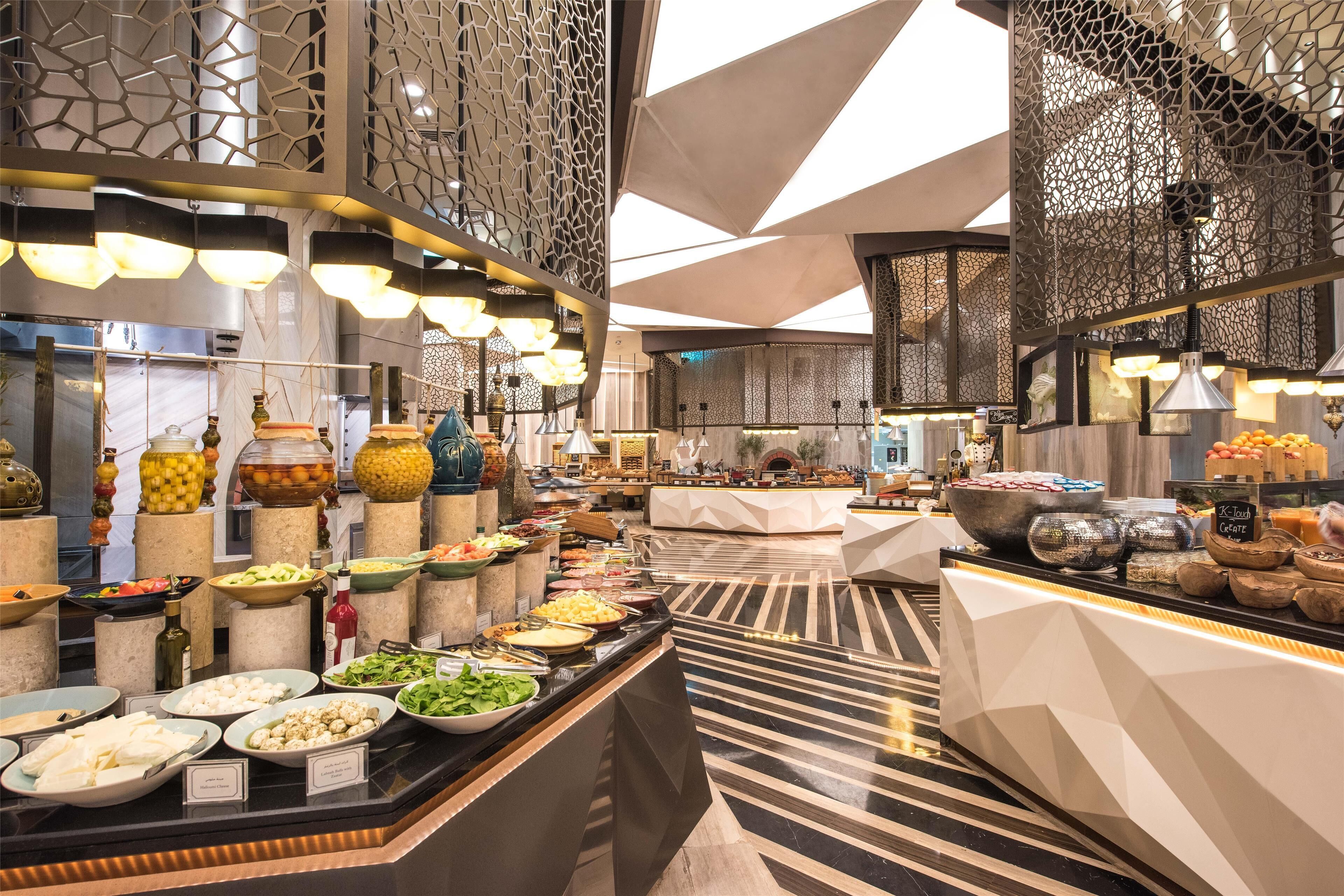 A buffet area with various food items and a modern interior design.
