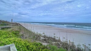 A beach with a wooden boardwalk and vegetation in the foreground. - Bright's Beach Front | Sound View + Walk to Beach! (Topsail Beach)